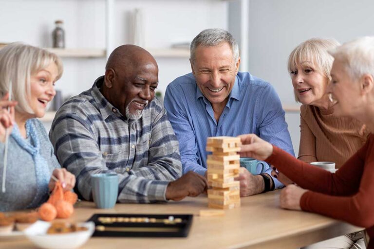 Older adults enjoying an activity together in a comfortable residential common area.